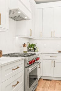 a kitchen with white cabinets and white counter tops